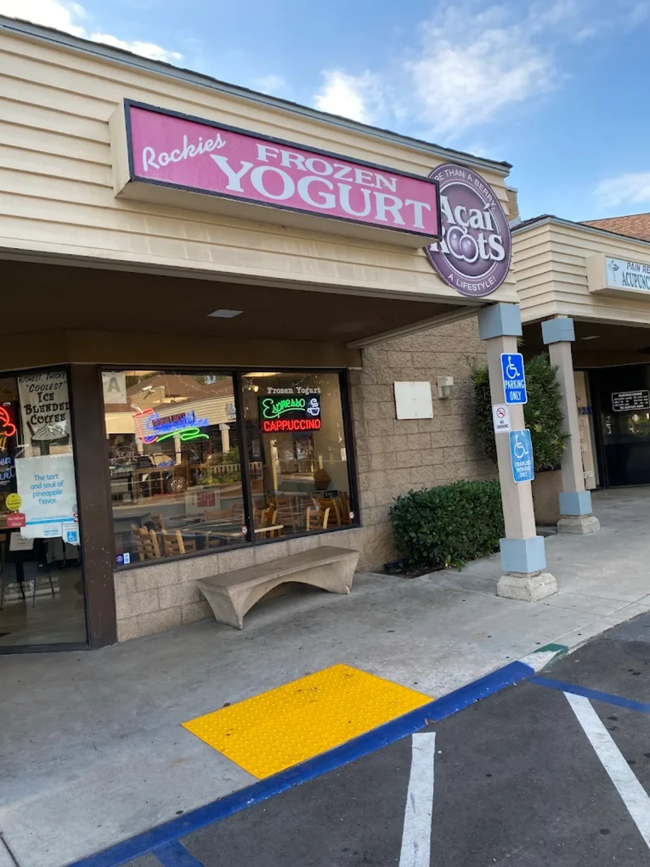 Rockie's Frozen Yogurt pink storefront sign by day