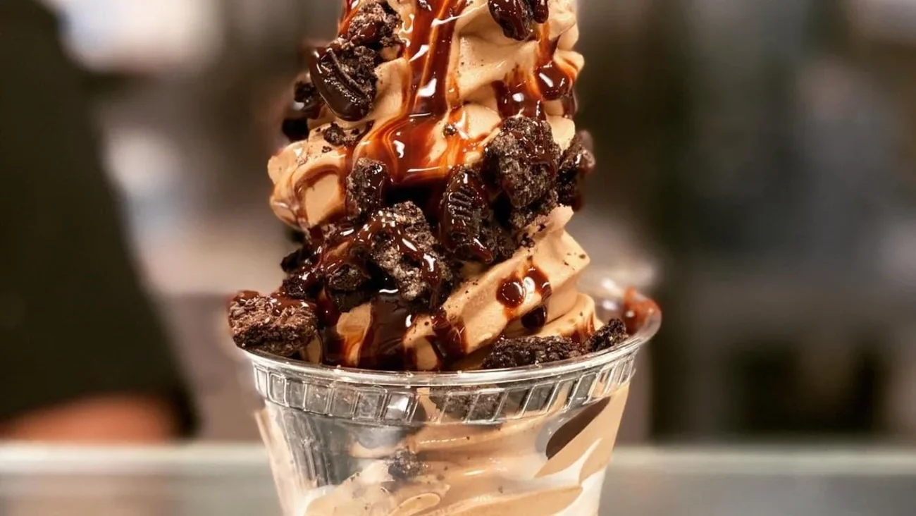A tall chocolate frozen yogurt swirl with cookie crumbles and fudge at Rockie's in San Diego